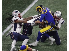 New England Patriots' Dont'a Hightower (54) and New England Patriots' Kyle Van Noy (53), center, sack Los Angeles Rams' Jared Goff (16) during the second half of the NFL Super Bowl 53 football game Sunday, Feb. 3, 2019, in Atlanta.