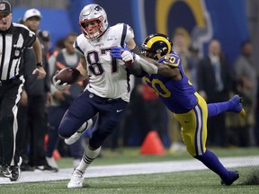 New England Patriots' Rob Gronkowski (87) runs from Los Angeles Rams' Samson Ebukam (50) after catching a pass during the second half of the NFL Super Bowl 53 football game Sunday, Feb. 3, 2019, in Atlanta.