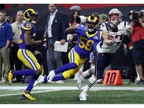 New England Patriots' Rob Gronkowski (87) catches a pass in front of Los Angeles Rams' Marcus Peters (22) and Cory Littleton (58) during the second half of the NFL Super Bowl 53 football game Sunday, Feb. 3, 2019, in Atlanta.