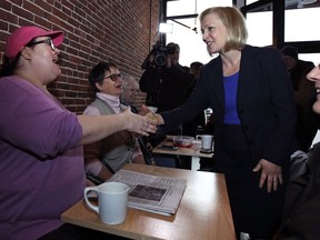 Sen. Kirsten Gillibrand, D-NY, shakes hands with a patron while visiting a coffee shop on Main Street in Concord, N.H., Friday, Feb. 15, 2019. Gillibrand visited New Hampshire as she explores a 2020 run for president.