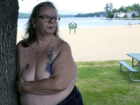 FILE - In this June 2, 2016 file photo, Heidi Lilley stands for a portrait near the spot where she was arrested by the Laconia, N.H. police. On Friday, Feb. 8, 2019, New Hampshire's highest court has upheld the conviction of three women arrested for going topless on a New Hampshire beach. In a 3-2 ruling, the court found Laconia's ordinance does not discriminate on the basis of gender or violate the women's right to free speech.
