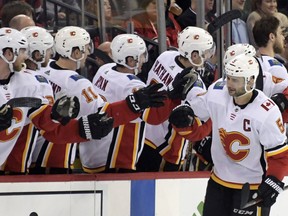 Calgary Flames defenseman Mark Giordano (5) celebrates his goal with teammates during the second period of an NHL hockey game against the New Jersey Devils Wednesday, Feb. 27, 2019, in Newark, N.J. the Flames won 2-1.