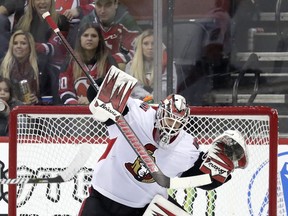 Ottawa Senators goaltender Anders Nilsson, of Sweden, blocks a shot from the New Jersey Devils during the first period of an NHL hockey game, Thursday, Feb. 21, 2019, in Newark, N.J.
