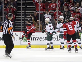 New Jersey Devils left wing Brett Seney, second from left, celebrates after scoring a goal on the Minnesota Wild during the first period of an NHL hockey game, Saturday, Feb. 9, 2019, in Newark, N.J.