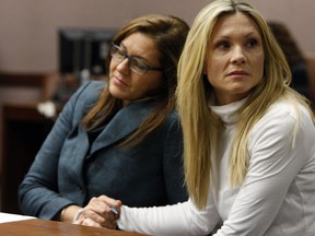 FILE - This Nov. 27, 2012 file photo shows attorney Ellen Torregrossa-O'Connor, left, holding the hand of former "Melrose Place" actress Amy Locane-Bovenizer, of Hopewell Township, N.J. as the jury in her trial returns a verdict in Somerville, N.J. Locane was sentenced Friday, Feb. 15, 2019, to 5 years behind bars. She served about 2½ years before her 2015 release. An appeals court ordered Locane to be re-sentenced after determining her initial sentence was too lenient.