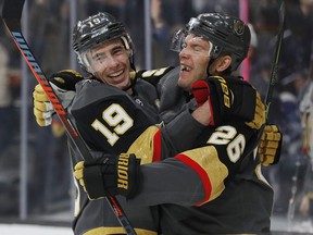 Vegas Golden Knights right wing Reilly Smith (19) celebrates after center Paul Stastny (26) scored against the Toronto Maple Leafs during the second period of an NHL hockey game Thursday, Feb. 14, 2019, in Las Vegas.