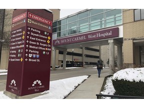 FILE - In this Jan. 15, 2019 file photo, the main entrance to Mount Carmel West Hospital is shown in Columbus, Ohio.  The Ohio hospital system investigating a doctor accused of ordering painkiller overdoses for dozens of patients says five who died may have received excessive doses when there still was a chance to improve their conditions with treatment. The Columbus-area Mount Carmel Health System said Friday, Feb. 22  it's notifying those patients' families.