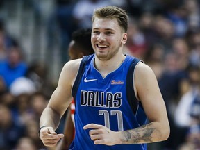 FILE - In this Nov. 6, 2018, file photo, Dallas Mavericks forward Luka Doncic (77) reacts after making a three-point shot during the first half of an NBA basketball game against the Washington Wizards, in Dallas. The step-back 3-pointer is the perfect weapon for the modern NBA, practically a necessity in a game where the ability to find space to shoot from behind the arc is more valued than ever before. Doncic has ridden it to stardom on both sides of the Atlantic.
