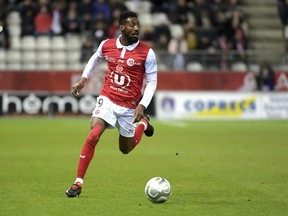 FILE - In this March 9, 2018, file photo, Reims' Anatole Ngamukol controls the ball during a league II soccer match against Chateauroux in Reims, eastern France. French soccer players are turning to the courts to fight workplace bullying and the practice known in France by an English word, "le loft."