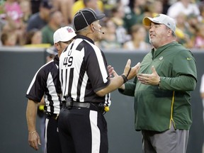 FILE - In this Aug. 4, 2018, file photo, Green Bay Packers head coach Mike McCarthy talks with officials during NFL football Family Night practice, in Green Bay, Wis. A complaint has been filed against former Green Bay Packers coach Mike McCarthy, accusing him of verbally confronting referees after a loss for his stepson's high school basketball team. The Pulaski School District confirms it was McCarthy who berated the officials and followed them as they were escorted from a game Tuesday, Feb. 26, 2019.