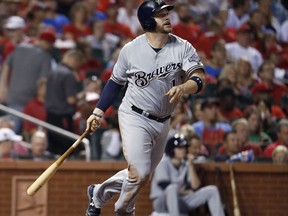 FILE - In this Sept. 29, 2017, file photo, Milwaukee Brewers' Stephen Vogt watches his solo home run during the fourth inning of a baseball game against the St. Louis Cardinals, in St. Louis. Free agent catcher Stephen Vogt is returning to the Bay Area, agreeing to a minor league contract with the San Francisco Giants. Vogt shared the news in a text message Monday, Feb. 11, 2019, when he was en route to the club's spring training complex in Scottsdale, Arizona, for Wednesday's pitchers and catchers reporting day.