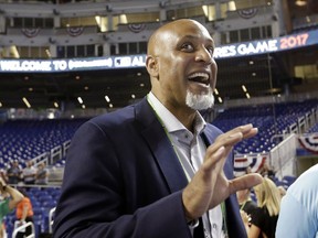 FILE - In this July 9, 2017, file photo, Tony Clark, head of the MLB Players Association, stands on the field before the All-Star Futures baseball game in Miami. Players' union head Tony Clark criticized baseball Commissioner Rob Manfred for blaming players' demands for the slow free agent market and said an increasing number of teams make little effort to "justify the price of a ticket."