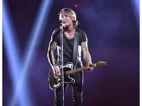 FILE - In this Nov. 14, 2018, file photo, Country music star Keith Urban performs at the 52nd annual CMA Awards at Bridgestone Arena in Nashville, Tenn. Urban will perform at the NHL's Stadium Series outdoor game in Philadelphia between the Penguins and Flyers on Feb. 23.