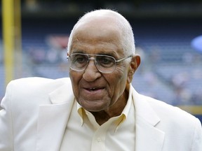 FILE - In this Aug. 18, 2012, file photo, former Dodgers pitcher Don Newcombe stands on the field at Turner Field, where he received the Beacon of Hope Award before the Civil Rights Game, in Atlanta. Newcombe, the hard-throwing Brooklyn Dodgers pitcher who was one of the first black players in the major leagues and who went on to win the rookie of the year, Most Valuable Player and Cy Young awards, has died. He was 92. The team confirmed that Newcombe died Tuesday morning, Feb. 19, 2019, after a lengthy illness.