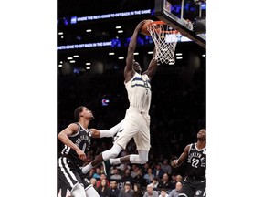 FILE - In this Feb. 4, 2018, file photo, Brooklyn Nets forward James Webb III (0) watches as Milwaukee Bucks center Thon Maker (7) dunks over him during the first half of an NBA basketball game, in New York. A person familiar with the situation says the NBA-leading Milwaukee Bucks have agreed to trade center Thon Maker to the Detroit Pistons for forward Stanley Johnson. The person spoke to The Associated Press Wednesday, Feb. 6, 2019, on condition of anonymity because the deal had not been publicly announced.