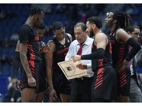 FILE - In this Feb. 14, 2019, file photo, Houston head coach Kelvin Sampson talks to his team during the first half of an NCAA college basketball game against Connecticut, in Hartford, Conn. The entire team piles into Sampson's house before each home game to prepare for the next opponent, eat his wife Karen's delicious homemade chocolate chip cookies and bond like a family. The routine is something Sampson and his players agree has created an environment of closeness and trust that is an integral ingredient in the ninth-ranked Cougars' success this season.