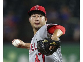 FILE - In this Tuesday, Sept. 4, 2018 file photo, Los Angeles Angels relief pitcher Junichi Tazawa (47) works the seventh inning against the Texas Rangers in a baseball game in Arlington, Texas. Reliever Junichi Tazawa has finalized a minor league contract with the Chicago Cubs and will report to big league spring training. If added to the 40-man roster, Tazawa would receive a one-year contract paying $800,000 while in the major leagues. He could earn $450,000 in performance bonuses for games pitched and $750,000 for games finished. The 32-year-old right-hander was with a 7.07 ERA in 31 games last season for Miami and the Los Angeles Angels.