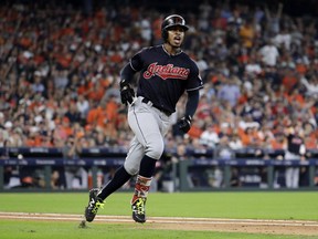 FILE - In this Oct. 6, 2018, file photo, Cleveland Indians' Francisco Lindor celebrates as he round the bases after hitting a solo home run against the Houston Astros during the third inning of Game 2 of a baseball American League Division Series, in Houston. The Indians All-Star shortstop will likely miss the start of the season with a strained right calf. Lindor, one of baseball's best all-around players, sustained the injury recently while working out in Orlando, Florida. He was checked Wednesday, Feb. 6, 2019, at the Cleveland Clinic by Dr. Mark Schickendantz, who confirmed a moderate sprain.