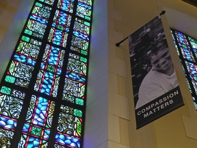 In this Tuesday, Feb. 12, 2019 photo, a banner hangs by a stained glass window in the sanctuary at Glide Memorial United Methodist Church in San Francisco. The United Methodist Church officially opens its top legislative assembly Sunday, Feb. 24, 2019, for a high-stakes three-day meeting likely to determine whether America's second-largest Protestant denomination will fracture due to long-simmering divisions over same-sex marriage and the ordination of LGBT clergy.
