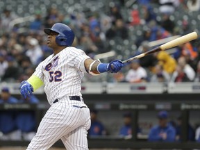 FILE - In this April 4, 2018, file photo, New York Mets' Yoenis Cespedes watches his two-run home run during the first inning of the baseball game against the Philadelphia Phillies at Citi Field in New York. Cespedes says he thinks he will be able to play at some point this season. Recovering from surgery on both heels, the Mets slugger told reporters through a translator at spring training Friday, Feb. 15, 2019, he is finally pain-free.