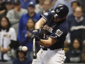 FILE - In this Oct. 5, 2018, file photo, Milwaukee Brewers' Mike Moustakas hits an RBI single during the eighth inning of Game 2 of the National League Divisional Series baseball game against the Colorado Rockies in Milwaukee. A person familiar with the negotiations says Moustakas and the Brewers are nearing a deal that would keep the third baseman in Milwaukee for a guarantee of about $10 million. The person spoke to The Associated Press on condition of anonymity Sunday, Feb. 17, 2019, because the agreement will be subject to a successful physical.