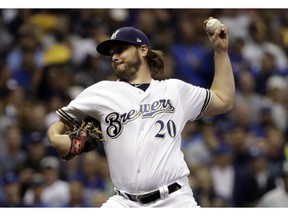 FILE - In this Oct. 19, 2018, file photo, Milwaukee Brewers starting pitcher Wade Miley throws during the first inning of Game 6 of the National League Championship Series baseball game against the Los Angeles Dodgers in Milwaukee. The Houston Astros filled an opening in their rotation, agreeing to a $4.5 million, one-year contract with 32-year-old left-hander Miley.