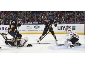 Chicago Blackhawks defenseman Brent Seabrook (7) goes to the ice to block a shot by Buffalo Sabres center Jack Eichel (9) during the second period of an NHL hockey game in Buffalo, N.Y., Friday, Feb. 1, 2019.