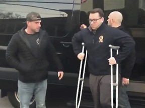 In this image taken from video, New York Police Department Sgt. Matthew Gorman, right, arrives home from the hospital to his Seaford, N.Y. home, Thursday, Feb. 14, 2019. Gorman was shot in the leg on Tuesday Feb. 12, while he and an NYPD detective responded to a robbery in progress at a mobile phone store in the Queens borough of New York.