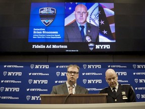 New York Police Department Chief Terence Monahan, right, and Deputy Chief Kevin Maloney, left, hold a press conference Wednesday Feb. 13, 2019, at police headquarters in New York. Officials say seven officers fired a total of 42 rounds during the chaotic scene that resulted in the friendly fire death of a New York Police Department Detective Brian Simonsen.