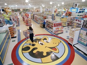 FILE- In this July 30, 1996, file photo, a woman pushes a shopping cart over a graphic of Toys R Us mascot Geoffrey the giraffe at the Toys R Us store in Raritan, N.J. Richard Barry, a former Toys R Us executive and now CEO of the new company called Tru Kids Inc., is exploring freestanding stores, shops within existing stores as well as e-commerce. Tru Kids, owned by former investors of Toys R Us, will manage the Toys R Us, Babies R Us and Geoffrey brands.s.