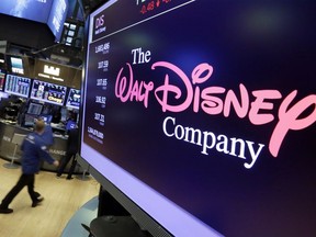 FILE- In this Monday, Aug. 7, 2017, file photo, the Walt Disney Co. logo appears on a screen above the floor of the New York Stock Exchange. The Walt Disney Co. reports financial results Tuesday, Feb. 5, 2019.