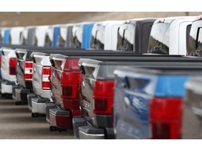 In this Sunday, Feb. 17, 2019, file photo, unsold 2019 F150 pickup trucks sit in a long row at a Ford dealership in Broomfield, Colo. On Tuesday, Feb. 26, the Conference Board releases its February index on U.S. consumer confidence.