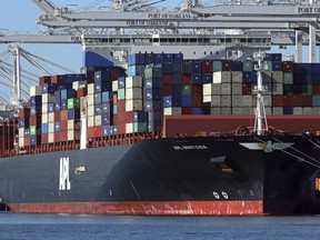 FILE- In this Dec. 6, 2018, file photo container ships docked at the Port of Oakland are unloaded on Thursday, Dec. 6, 2018, in Oakland, Calif. On Wednesday, Feb. 6, the Commerce Department reports on the U.S. trade gap for November.