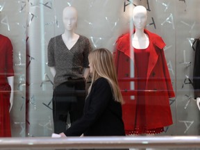FILE- In this Dec. 24, 2018, file photo a woman walks by mannequins at the Cherry Creek Mall in Denver. The National Retail Federation, the nation's largest retail trade group, says that holiday sales increased a lower-than-expected 2.9 percent as worries about the trade war with China, the government shutdown and stock market turmoil dampened shopper spending in December.