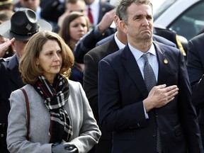 FILE - In this Feb. 9, 2019 file photo, Virginia Gov. Ralph Northam, right, and his wife Pam, watch as the casket of fallen Virginia State Trooper Lucas B. Dowell is carried to a waiting tactical vehicle during the funeral at the Chilhowie Christian Church in Chilhowie, Va. Virginia First Lady Pam Northam has expressed regret after the mother of an African American teenager complained about a tour of the governor's mansion she said was racially insensitive. Northam said Wednesday, Feb. 27 that is she is working to make sure the stories of slaves who worked in the mansion's historic kitchen before the Civil War are told properly. Northam's statement comes amid heightened racial tension in Virginia politics. Gov. Ralph Northam has recently apologized for wearing blackface decades ago.