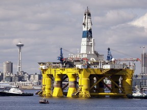 FILE - In this May 14, 2015, file photo, the oil drilling rig Polar Pioneer is towed toward a dock in Elliott Bay in Seattle. The government says U.S. oil production will keep climbing and set new records in 2019 and 2020 while oil prices will remain below last year's levels. The U.S. Energy Information Administration said Tuesday, Feb. 12, 2019, it expects the United States to pump 12.4 million barrels of crude a day in 2019 and 13.2 million barrels a day in 2020.