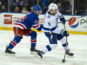 Tampa Bay Lightning's Tyler Johnson takes a shot as he gets past New York Rangers Neil Pionk in the first period of an NHL hockey game Wednesday, Feb. 27, 2019, at Madison Square Garden in New York.