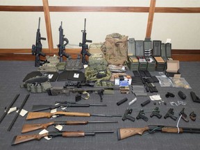 FILE - This image provided by the U.S. District Court in Maryland shows a photo of firearms and ammunition that was in the motion for detention pending trial in the case against Christopher Paul Hasson.  The Coast Guard officer, accused of being a white supremacist who compiled a hit list of prominent Democrats, was indicted Wednesday, Feb. 27, 2019, on firearms and drug charges. (U.S. District Court via AP, File)