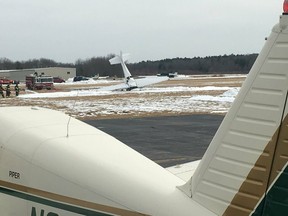 A small plane is seen resting on its nose following a crash and fire at Mansfield Municipal Airport in Mansfield, Mass., on Saturday, Feb. 23, 2019.  Massachusetts State Police confirmed that two people died in the crash, which occurred around 12:36 p.m.