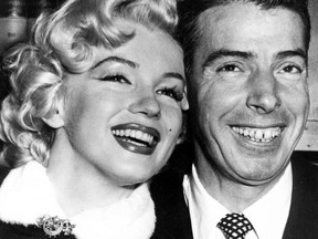 FILE - In this Jan. 14, 1954 file photo, New York Yankees' Joe DiMaggio, right, poses with actress Marilyn Monroe, as they wait for their marriage ceremony in San Francisco. The black dress that a distraught Marilyn Monroe wore to a 1954 press conference announcing her separation from baseball legend Joe DiMaggio is going up for auction. KruseGWS Auctions announced Wednesday that the simple wool dress with a zippered turtleneck front will be up for bidding starting on March 30. Monroe was wearing it in Beverly Hills on Oct. 6, 1954 when she stepped out amid a mob of cameras and reporters to announce the split in a marriage. (AP Photo, File)