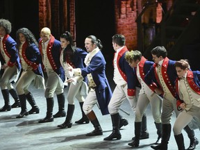 FILE - In this June 12, 2016 file photo, Lin-Manuel Miranda, center, and the cast of "Hamilton" perform at the Tony Awards in New York. Ever since the historical musical began its march to near-universal infatuation, one group has noticeable withheld its applause, historians. Many academics argue the onstage portrait of Alexander Hamilton is a counterfeit. Now they're escalating their fight.