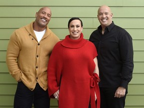 Dwayne Johnson, left, and Dany Garcia, center, co-founders and co-CEOs of Seven Bucks Productions, and her brother Hiram Garcia, the company's president of production, pose together during the 2019 Sundance Film Festival, Monday, Jan. 28, 2019, in Park City, Utah. Johnson put on his independent film producer hat to make his latest film, "Fighting With My Family."