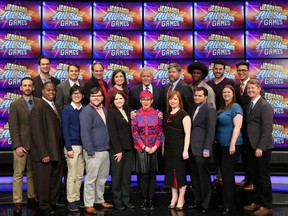 This image released by Jeopardy Productions, Inc. shows, front row from left, Brad Rutter, Colby Burnett, Alan Lin, Seth Wilson, Larissa Kelly, Monica Thieu, Pam Mueller, Matt Jackson, Jennifer Giles and Ken Jennings, back row from left, Ben Ingram,  Roger Craig, David Madden, Julia Collins, host Alex Trebek, Austin Rogers, Leonard Cooper, Alex Jacob and Buzzy Cohen on the set of the game show "Jeopardy!"  The game show's first-ever team tournament will pit groups of former champions against each other in 10 weekday episodes airing from Wednesday, Feb. 20, to Tuesday, March 5. (Jeopardy Productions, Inc. via AP)