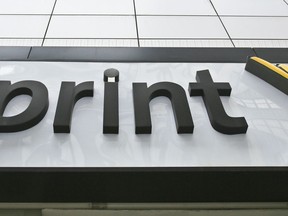 FILE - This April 30, 2018, file photo shows signage for a Sprint store in New York's Herald Square. The top executives of T-Mobile and Sprint are making the case to Congress that their proposed $26.5 billion merger wouldn't hurt competition and jack up the prices consumers pay for wireless service.