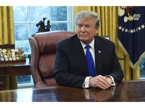 FILE - In this Friday, Feb. 22, 2019, file photo, President Donald Trump listens during his meeting with Chinese Vice Premier Liu He in the Oval Office of the White House in Washington. Trump said Sunday he will extend a deadline to escalate tariffs on Chinese imports, citing "substantial progress" in weekend talks between the two countries.