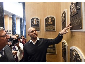 Baseball Hall of Fame inductee Mariano Rivera looks at fellow Panamanian Rod Carew's plaque while visiting the National Baseball Hall of Fame and Museum, Friday, Feb. 1, 2019, in Cooperstown, N.Y. The former New York Yankees closer will be inducted on July 21.