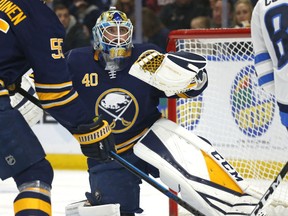 Buffalo Sabres goalie Carter Hutton (40) makes a glove-save during the first period of an NHL hockey game against the Winnipeg Jets, Sunday, Feb. 10, 2019, in Buffalo N.Y.