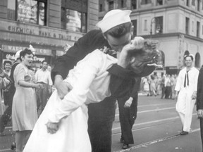 FILE - In this Aug. 14, 1945 file photo provided by the U.S. Navy, a sailor and a woman kiss in New York's Times Square, as people celebrate the end of World War II. The ecstatic sailor shown kissing a woman in Times Square celebrating the end of World War II has died. George Mendonsa was 95. It was years after the photo was taken that Mendonsa and Greta Zimmer Friedman, a dental assistant in a nurse's uniform, were confirmed to be the couple.