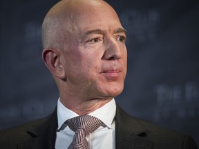 FILE- In this Sept. 13, 2018, file photo Jeff Bezos, Amazon founder and CEO, speaks at The Economic Club of Washington's Milestone Celebration in Washington. An attorney for the head of the National Enquirer's parent company says the tabloid didn't commit extortion or blackmail by threatening to publish Bezos' explicit photos. Elkan Abramowitz represents American Media Inc. CEO David Pecker. He defended the tabloid's practice as a "negotiation" in an interview Sunday, with ABC News.