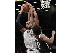 Brooklyn Nets forward Ed Davis (17) defends against a shot by San Antonio Spurs center LaMarcus Aldridge (12) during the first half of an NBA basketball game, Monday, Feb. 25, 2019, in New York.